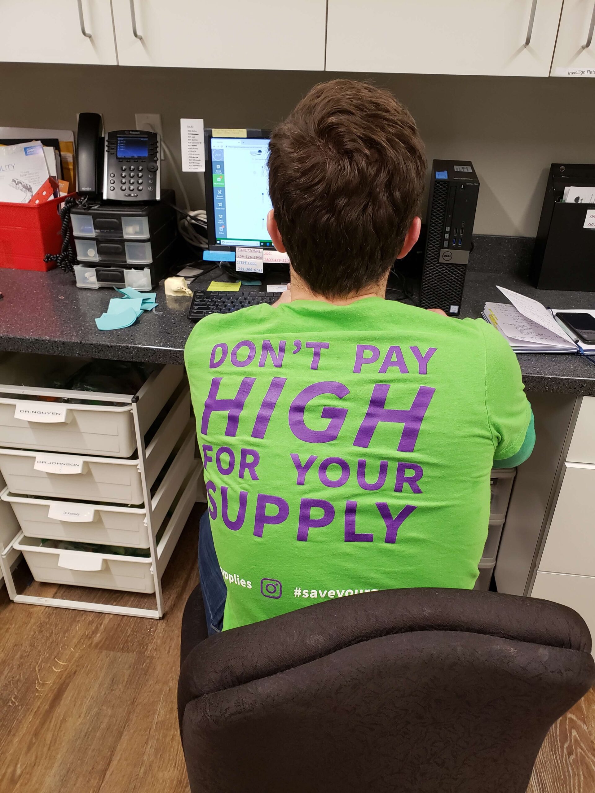 Tiger working on inventory in his green ZenSupplies shirt. "Don't pay high for your supply"